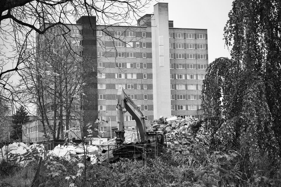 A construction excavator amidst rubble.